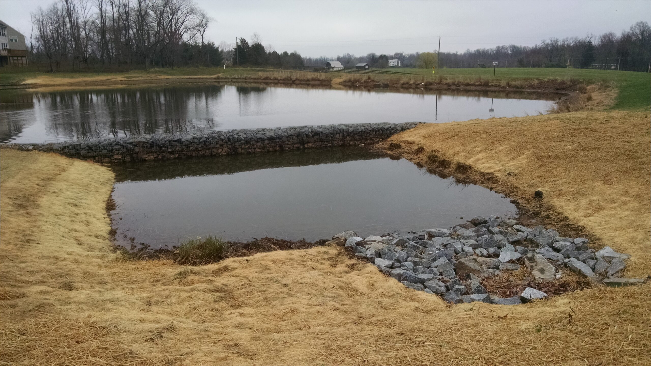 Area of water next to pond divided by a stone wall called a forebay