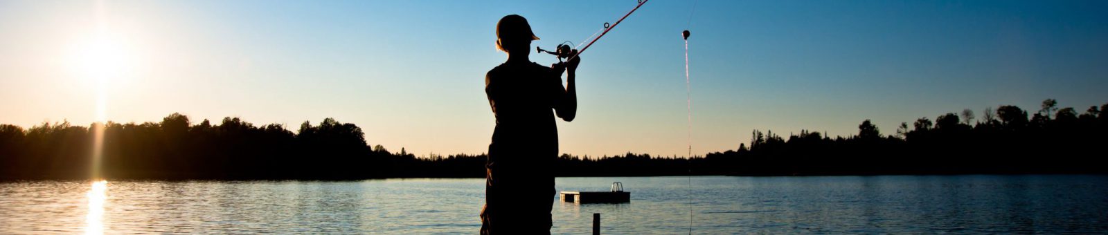 Boy fishing off a pier