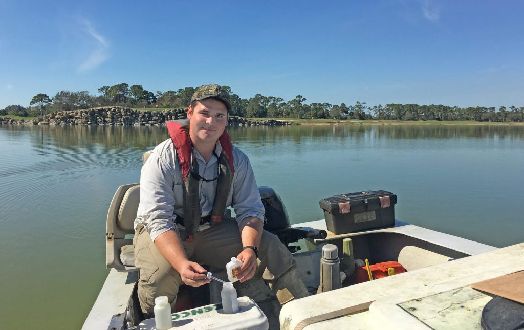 Waterbody characteristics - water testing water quality on the job team photo smiling colleague - scenic lake