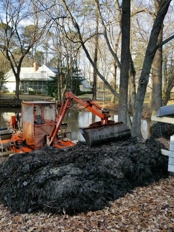 hydro-raking - in many cases, shoreline restoration - muck on shoreline - sediment and debris removal - hydro-raking scooping muck - deepen pond depth