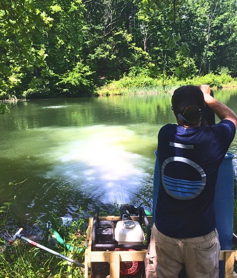 SOLitude Aquatic Expert applying Phoslock to the water - nutrient remediation - lanthanum-modified clay