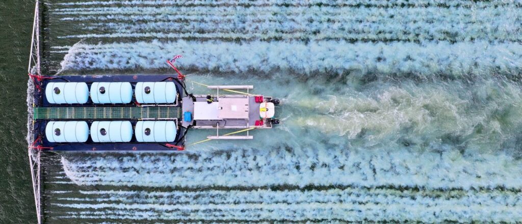 aerial view of alum barge applying an alum treatment to a community waterbody