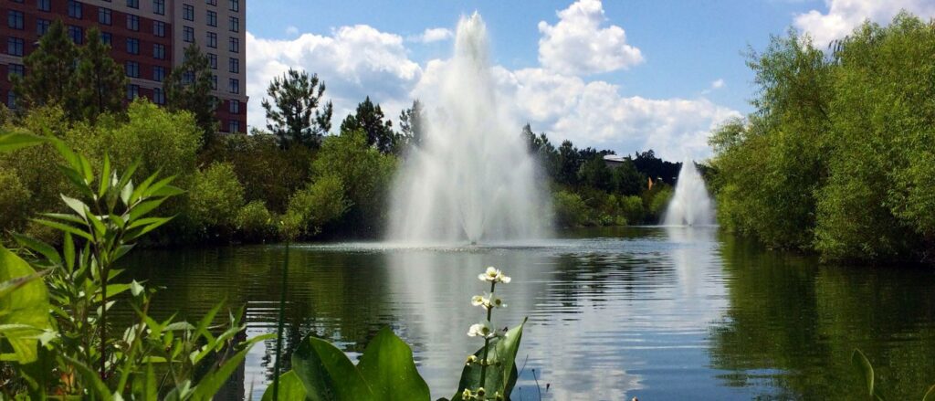 beautiful retention pond near a building with 2 floating aeration fountains