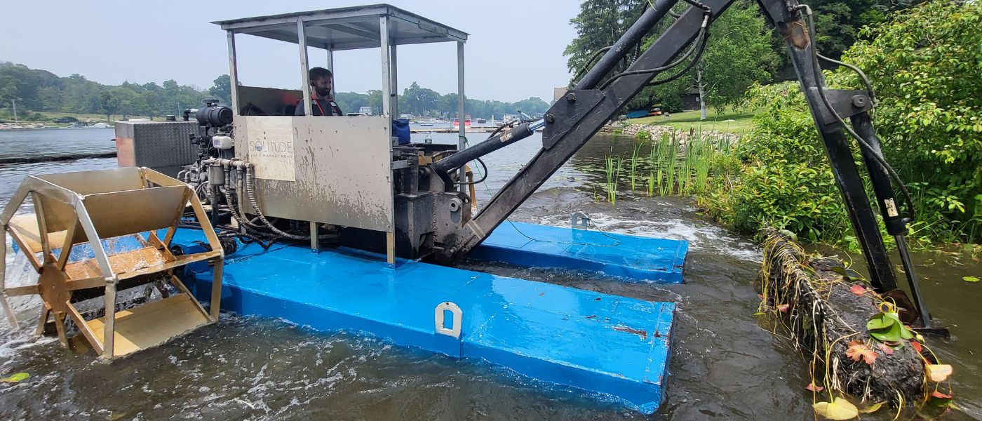 hydro-rake removing accumulated muck from lake